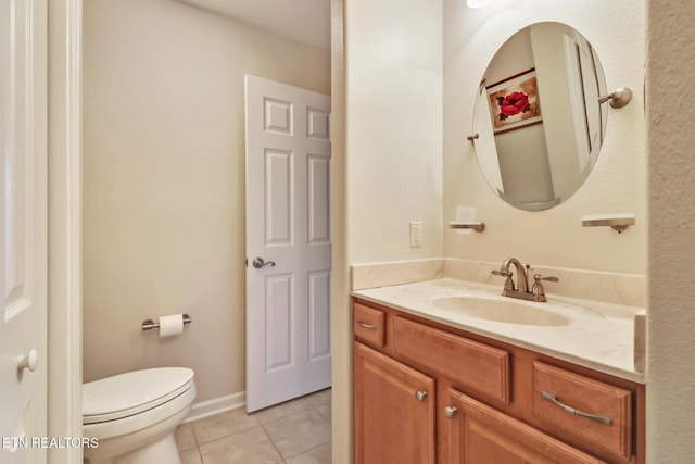 bathroom featuring vanity, tile patterned floors, and toilet