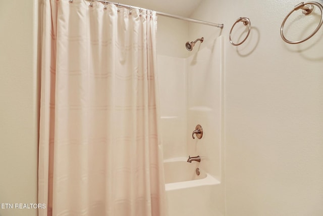 bathroom with shower / bath combo