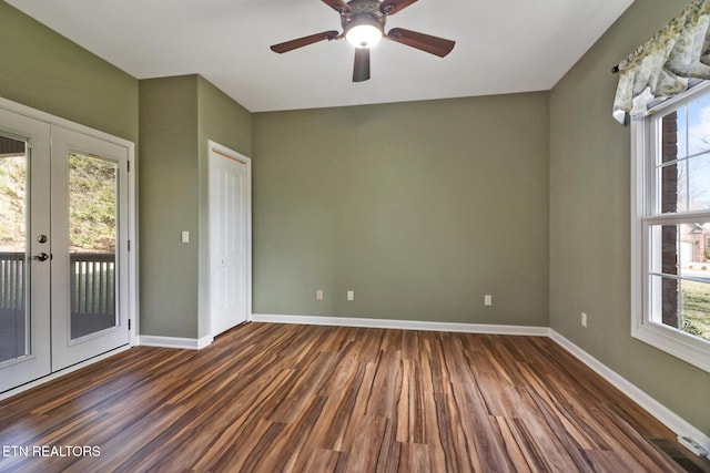 unfurnished room featuring french doors, plenty of natural light, baseboards, and wood finished floors