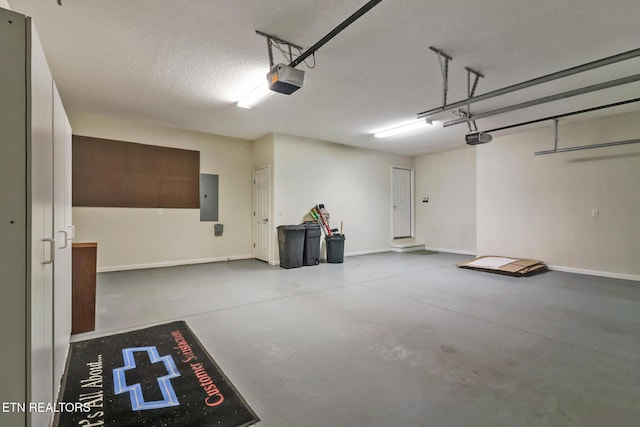 garage with electric panel, a garage door opener, and baseboards