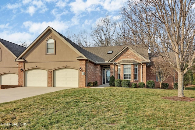 view of front of home with a front yard, driveway, stucco siding, a garage, and brick siding