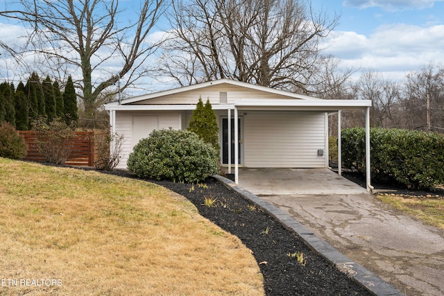 view of front facade with a carport and a front yard