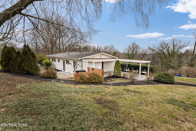 exterior space featuring a carport and a yard