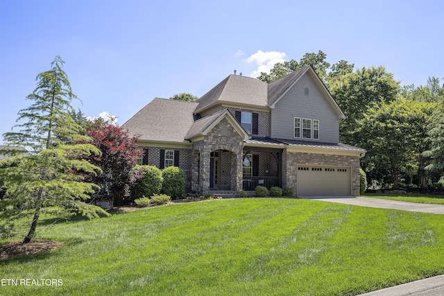 view of front of home with a garage and a front yard