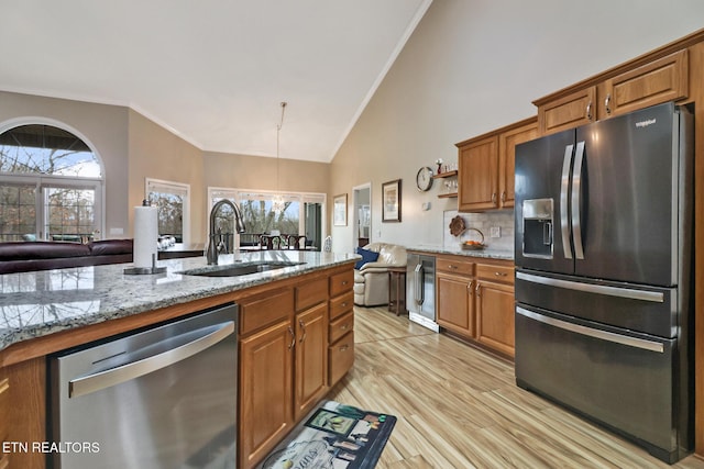 kitchen featuring wine cooler, stainless steel appliances, sink, and plenty of natural light