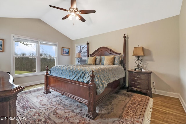 bedroom featuring hardwood / wood-style floors, vaulted ceiling, and ceiling fan