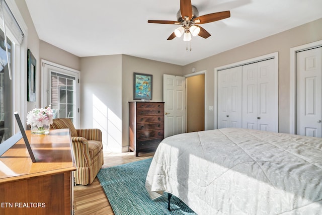 bedroom with multiple closets, ceiling fan, and light wood-type flooring