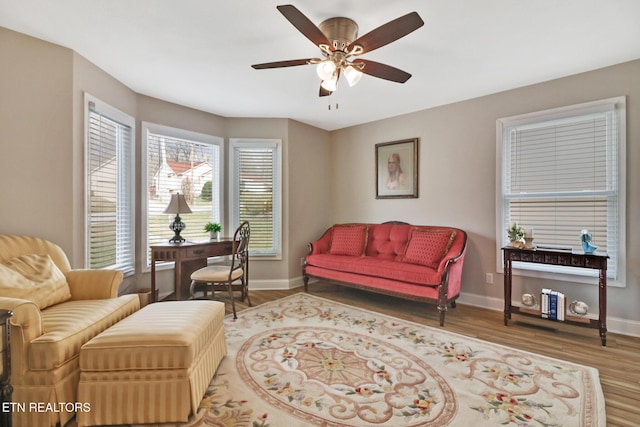 sitting room with hardwood / wood-style flooring and ceiling fan