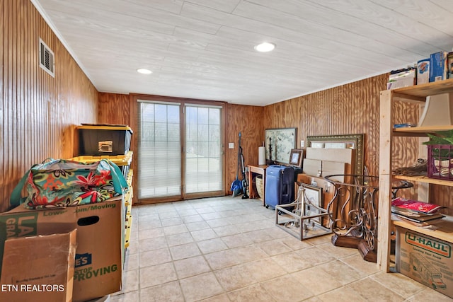 recreation room with light tile patterned flooring and wooden walls