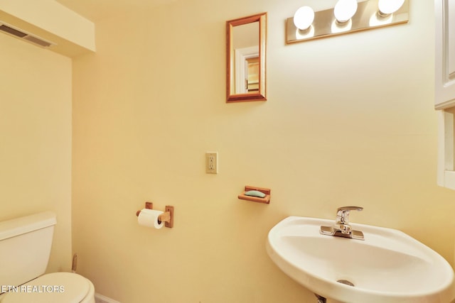 bathroom with toilet and sink