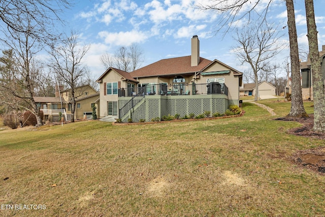 rear view of property with a wooden deck and a lawn