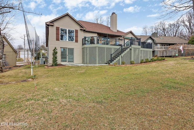 rear view of house featuring a yard, central AC, and a deck