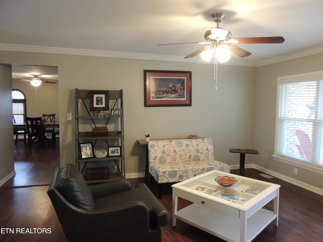 living room with ornamental molding, a healthy amount of sunlight, and dark wood-type flooring