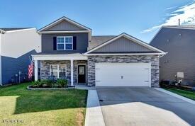 view of front of house featuring a garage and a front lawn