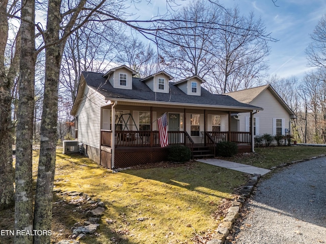 view of front of property with cooling unit, a front yard, and a porch