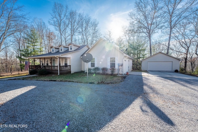 view of front facade featuring a garage, an outdoor structure, and covered porch