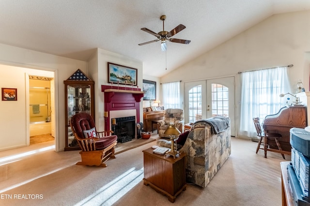 living room featuring light colored carpet, french doors, and a textured ceiling