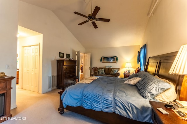 carpeted bedroom featuring ceiling fan and high vaulted ceiling