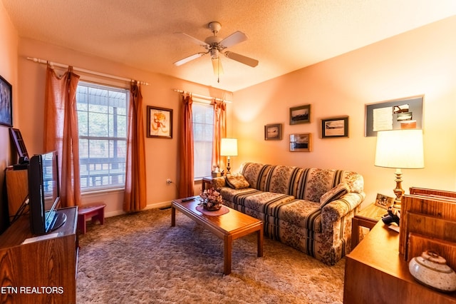 carpeted living room featuring ceiling fan and a textured ceiling