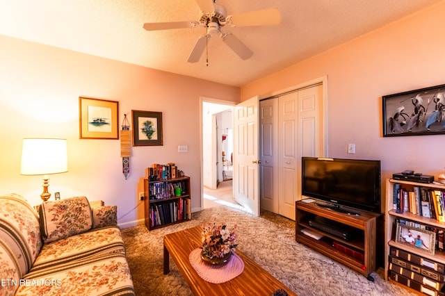 carpeted living room featuring ceiling fan