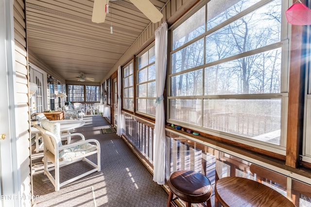 sunroom / solarium featuring ceiling fan