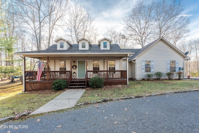 view of front of property with covered porch and a front lawn