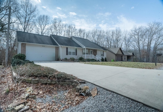 ranch-style house with a garage and covered porch