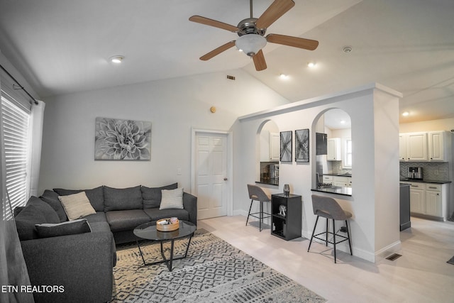 living room with lofted ceiling and ceiling fan