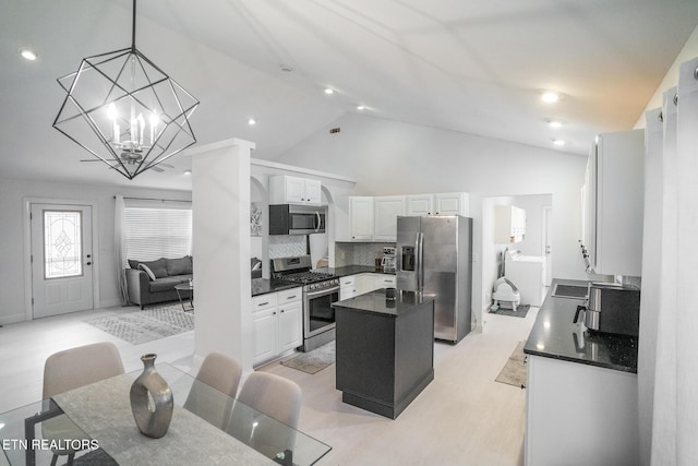 kitchen with stainless steel appliances, white cabinetry, a center island, and pendant lighting