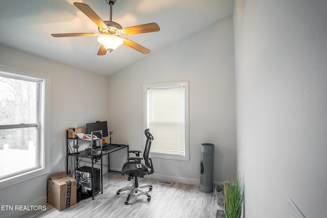 home office featuring lofted ceiling, ceiling fan, and light wood-type flooring