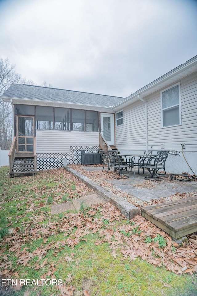 back of property featuring a sunroom