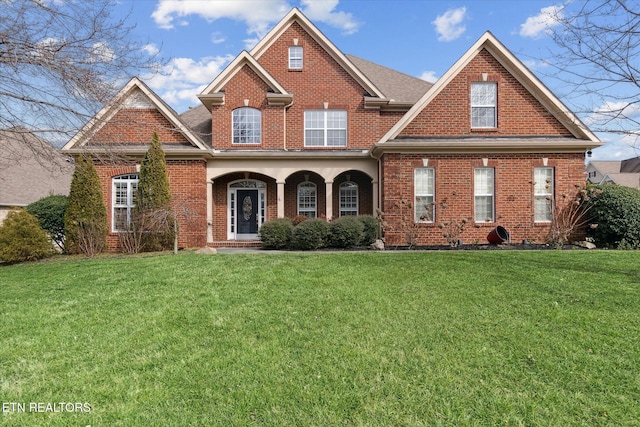 view of front facade with a front yard and covered porch