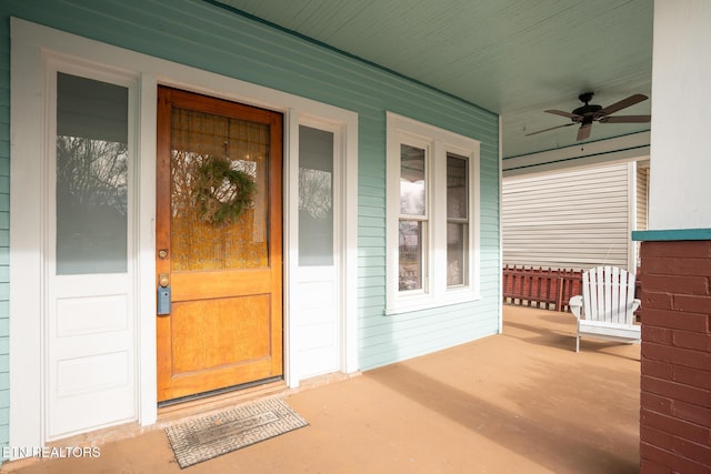 entrance to property featuring ceiling fan and covered porch