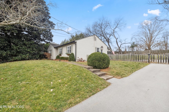 view of property exterior with a lawn