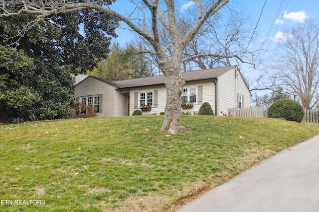 ranch-style home with a front yard