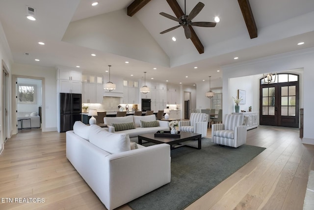 living area with high vaulted ceiling, light wood-type flooring, french doors, and beamed ceiling