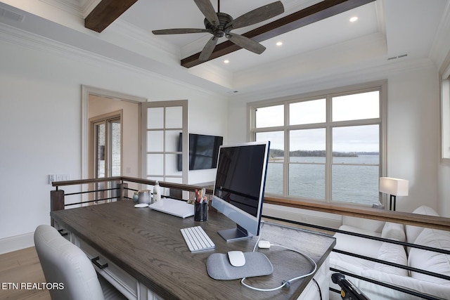 home office with a healthy amount of sunlight, beamed ceiling, visible vents, and wood finished floors