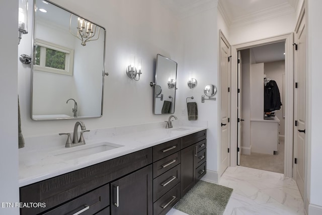 full bathroom featuring double vanity, a spacious closet, ornamental molding, and a sink