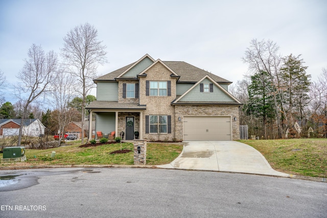 craftsman-style house featuring a garage, a front yard, and covered porch