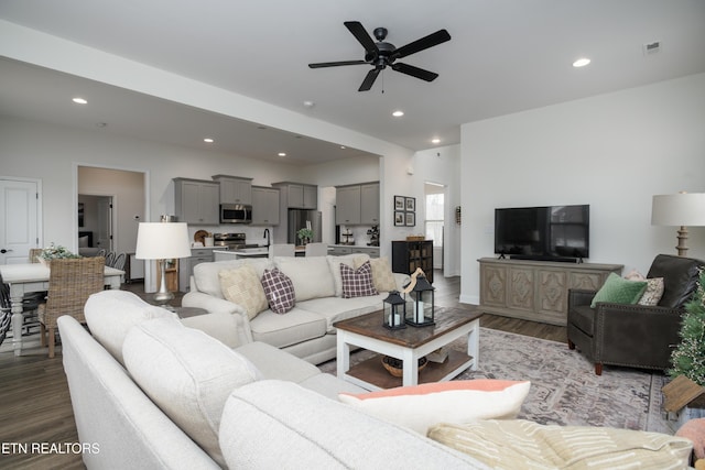 living room with hardwood / wood-style flooring and ceiling fan