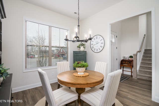 dining area featuring dark hardwood / wood-style flooring and a notable chandelier