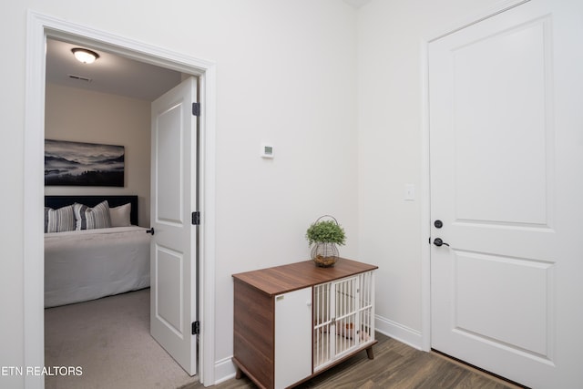 hall with dark wood-type flooring