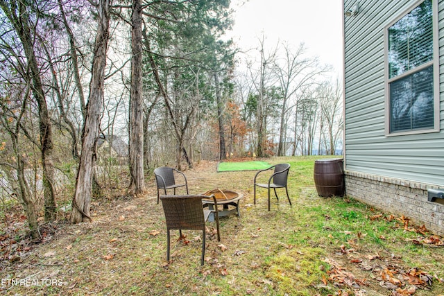 view of yard with an outdoor fire pit