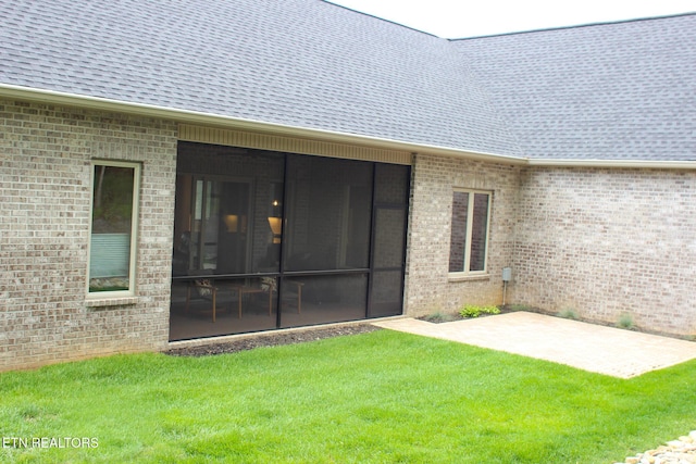116 Unole Trl, Vonore, TN 37885 - rear view of house featuring a yard, roof with shingles, a patio, and brick siding