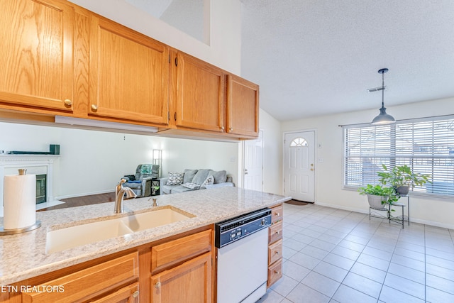 kitchen with light stone counters, dishwasher, sink, and hanging light fixtures