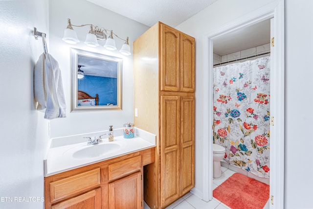 bathroom with vanity, toilet, and tile patterned flooring