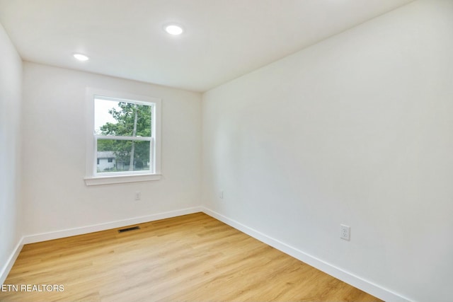 spare room featuring light hardwood / wood-style flooring