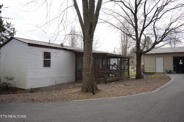 view of front facade featuring a garage and a sunroom