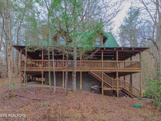 rear view of house featuring a deck