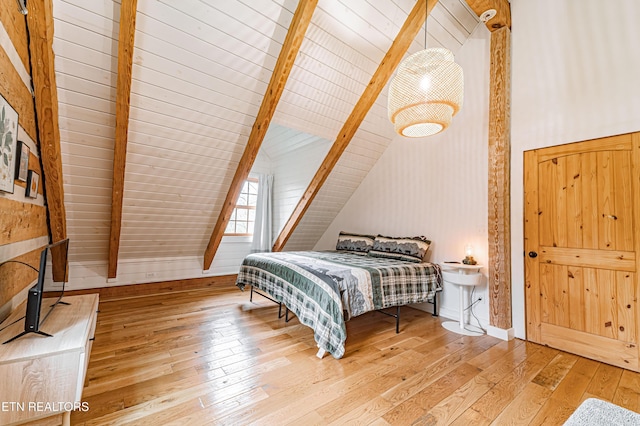 bedroom with hardwood / wood-style flooring and lofted ceiling with beams